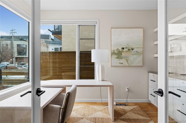 home office featuring wood finished floors and baseboards