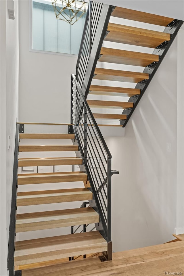 stairs featuring wood finished floors