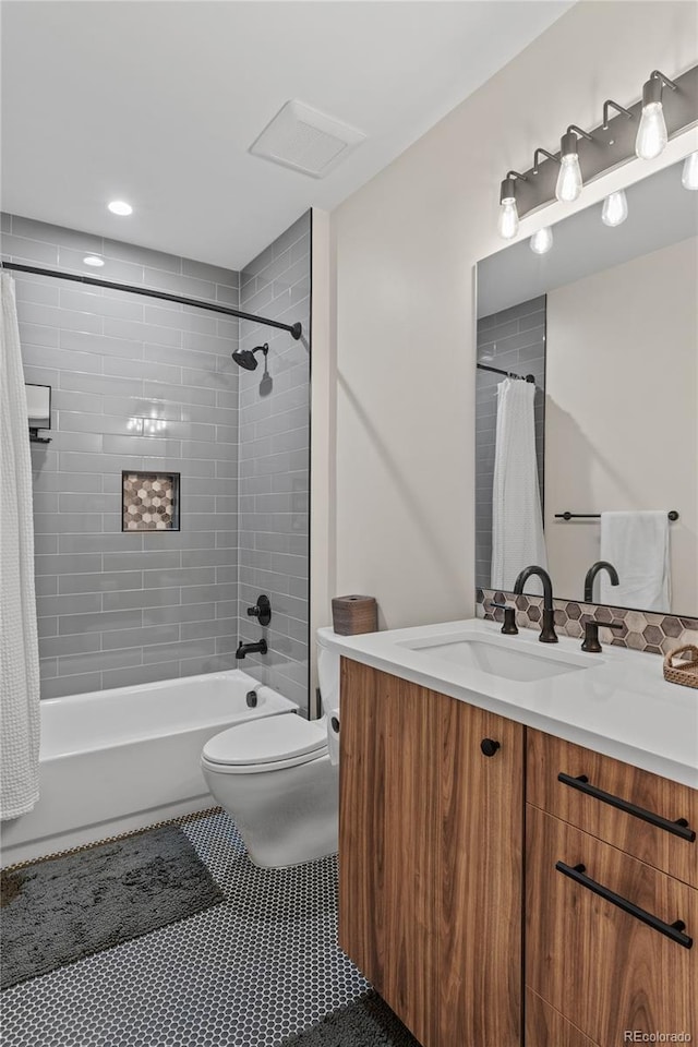 bathroom with tile patterned flooring, shower / tub combo with curtain, vanity, and toilet