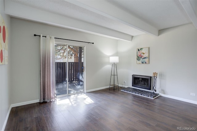 unfurnished living room with a fireplace, a textured ceiling, wood finished floors, beamed ceiling, and baseboards