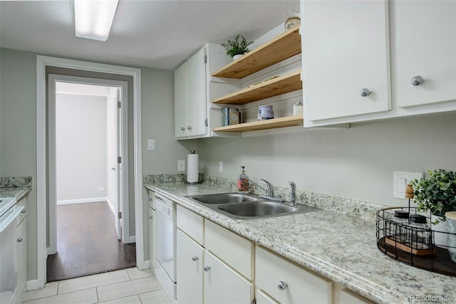 kitchen with white cabinetry, a sink, dishwasher, and open shelves