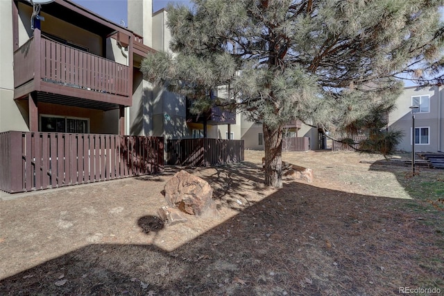 view of yard with an outdoor structure and fence