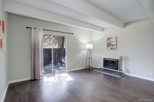 unfurnished living room featuring a brick fireplace, baseboards, beam ceiling, and wood finished floors