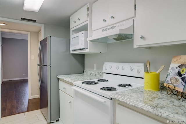kitchen with baseboards, white appliances, white cabinetry, under cabinet range hood, and visible vents
