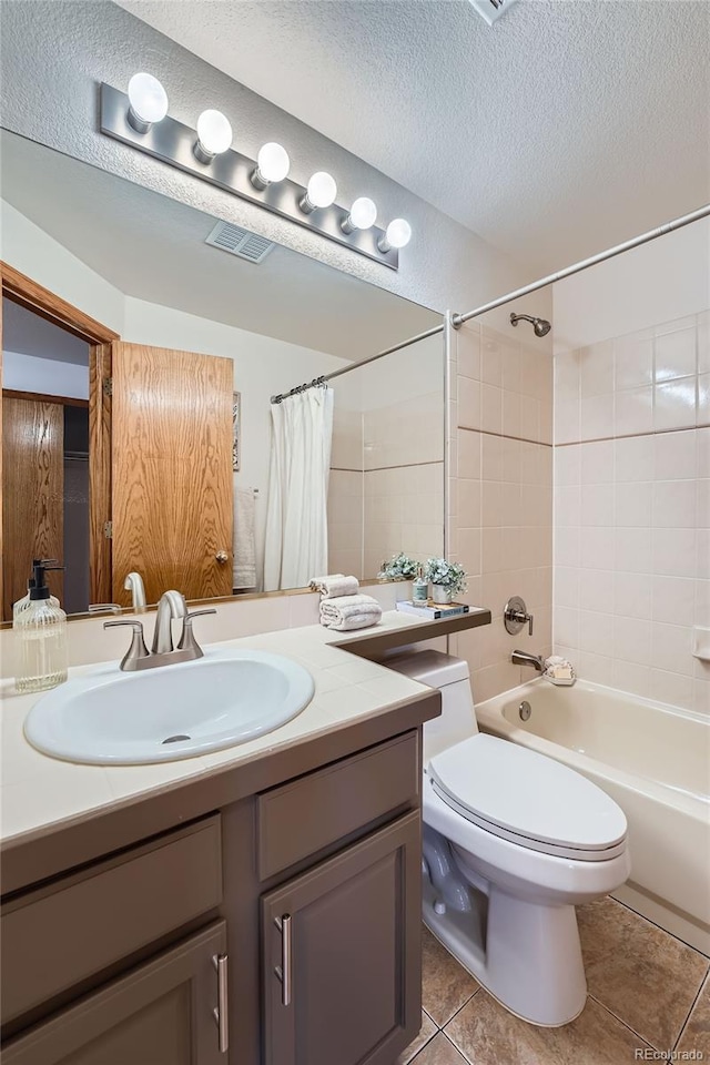 5394 S Valdai Way, Aurora, CO 80015 - bathroom featuring vanity, a textured ceiling, shower / tub combo, and tile patterned floors