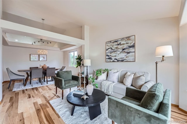 5394 S Valdai Way, Aurora, CO 80015 - living area featuring light wood-style floors and a tray ceiling