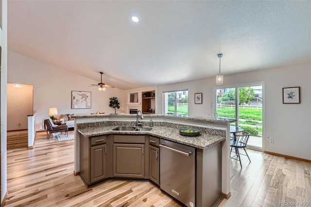 5394 S Valdai Way, Aurora, CO 80015 - kitchen with dishwasher, open floor plan, light wood-style flooring, light stone countertops, and lofted ceiling