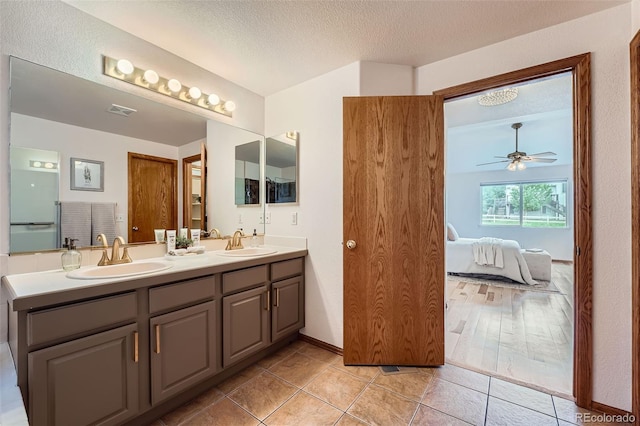 5394 S Valdai Way, Aurora, CO 80015 - full bath featuring ensuite bath, double vanity, ceiling fan, tile patterned floors, and a textured ceiling