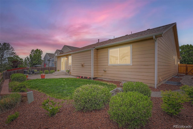 5394 S Valdai Way, Aurora, CO 80015 - back of house at dusk featuring a patio