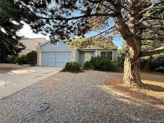 17969 E Brown Pl, Aurora, CO 80013 - view of front of house with concrete driveway, a garage, and brick siding