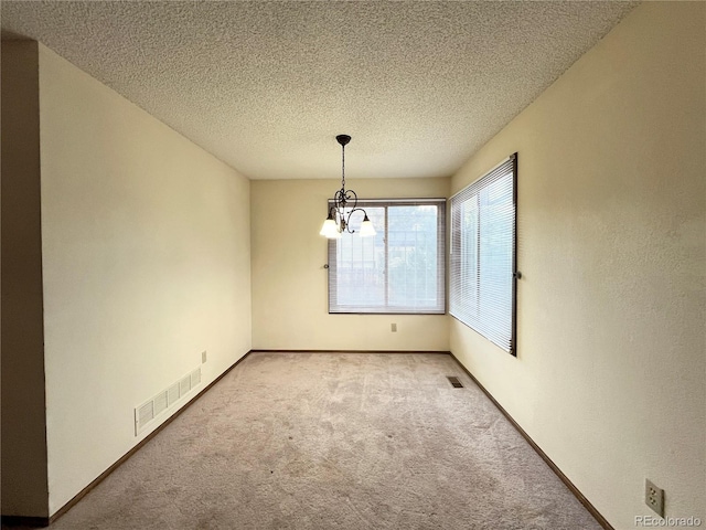 17969 E Brown Pl, Aurora, CO 80013 - unfurnished room featuring carpet flooring, a chandelier, and a textured ceiling