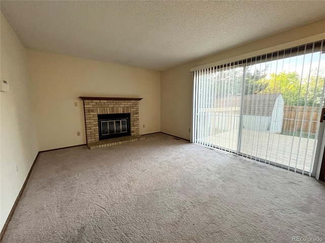 17969 E Brown Pl, Aurora, CO 80013 - unfurnished living room with plenty of natural light, carpet, a textured ceiling, a brick fireplace, and baseboards