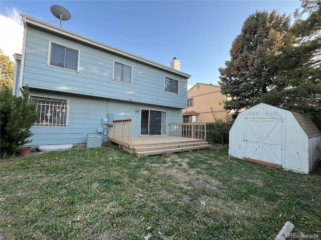 17969 E Brown Pl, Aurora, CO 80013 - back of house featuring a chimney, a wooden deck, and a yard