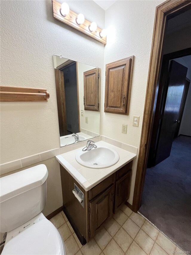 17969 E Brown Pl, Aurora, CO 80013 - half bath featuring vanity, toilet, and tile patterned floors