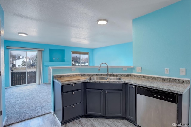 kitchen featuring kitchen peninsula, dishwasher, light hardwood / wood-style flooring, and sink