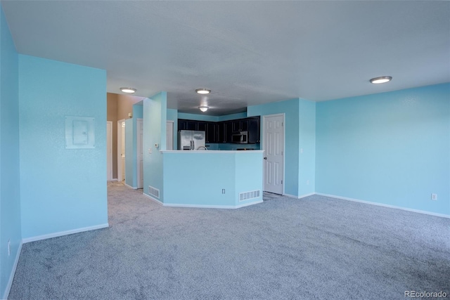 unfurnished living room featuring carpet flooring