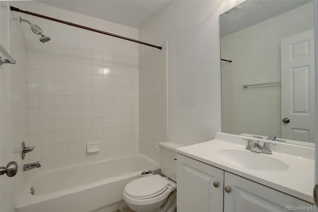 full bathroom featuring toilet, vanity, and tiled shower / bath