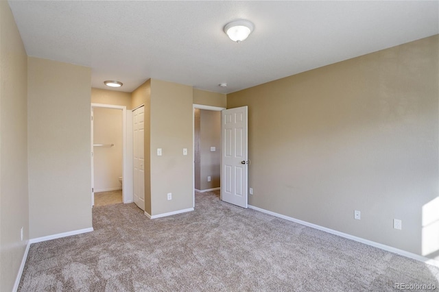 unfurnished bedroom with a closet and light carpet