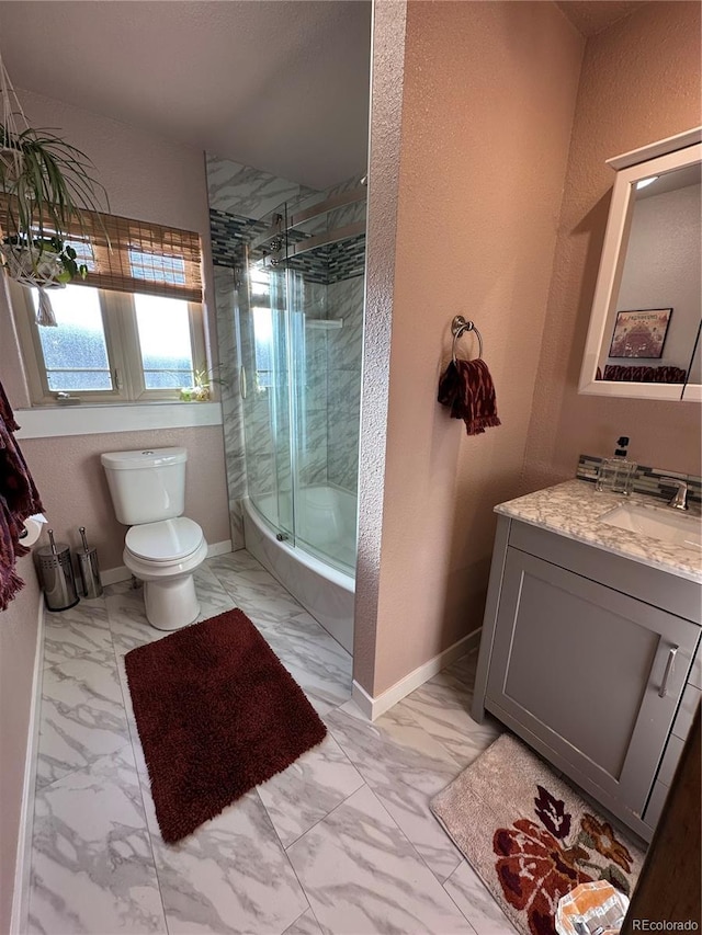 full bath with vanity, toilet, baseboards, and marble finish floor