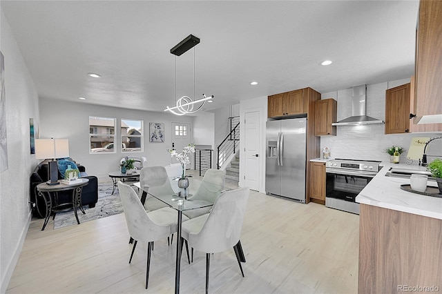 dining space with sink and light hardwood / wood-style flooring