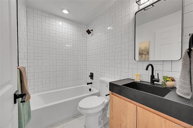 full bathroom featuring tile walls, decorative backsplash, tiled shower / bath combo, vanity, and toilet