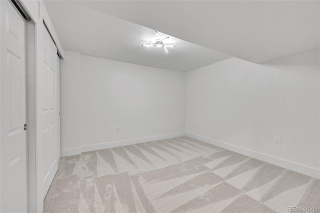 interior space featuring light carpet and a textured ceiling