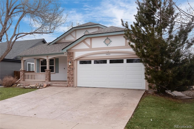 view of front of home featuring a garage, a porch, and a front lawn