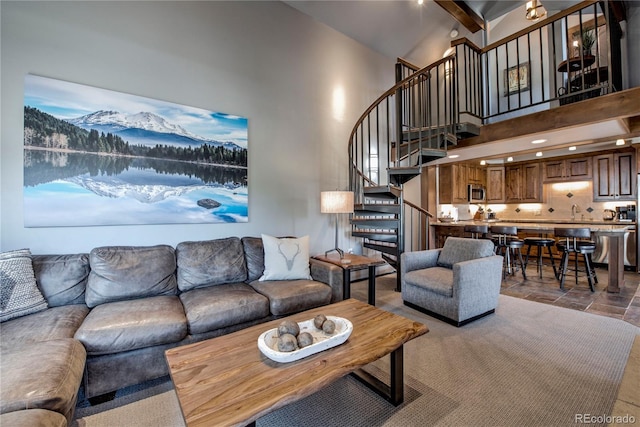 107 Ski Watch Rd Unit 32, Breckenridge, CO 80424 - living room featuring stairway, high vaulted ceiling, stone tile floors, beam ceiling, and a mountain view