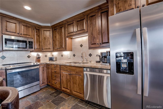 107 Ski Watch Rd Unit 32, Breckenridge, CO 80424 - kitchen with stainless steel appliances, tasteful backsplash, dark stone finish floors, light stone counters, and recessed lighting