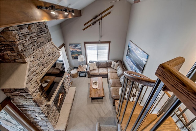 107 Ski Watch Rd Unit 32, Breckenridge, CO 80424 - carpeted living room with stairway, rail lighting, and a towering ceiling
