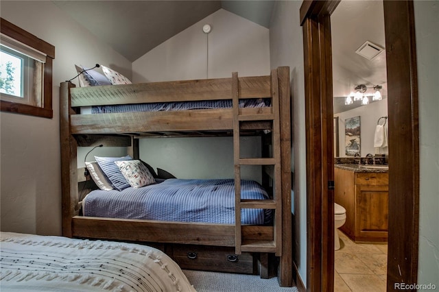 107 Ski Watch Rd Unit 32, Breckenridge, CO 80424 - bedroom featuring lofted ceiling, ensuite bath, and light tile patterned floors