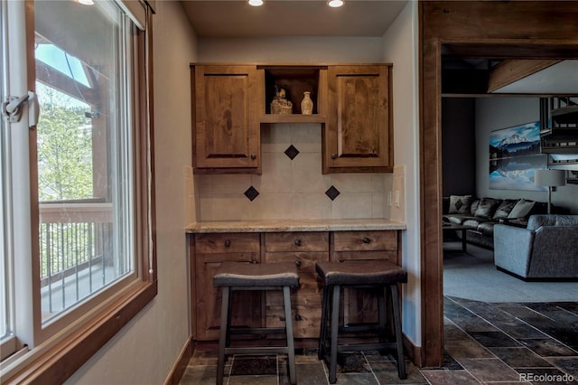 107 Ski Watch Rd Unit 32, Breckenridge, CO 80424 - bar area with backsplash, recessed lighting, and dark stone finish floors