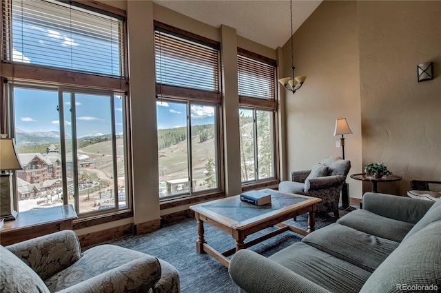 107 Ski Watch Rd Unit 32, Breckenridge, CO 80424 - living room with high vaulted ceiling, a chandelier, and carpet flooring