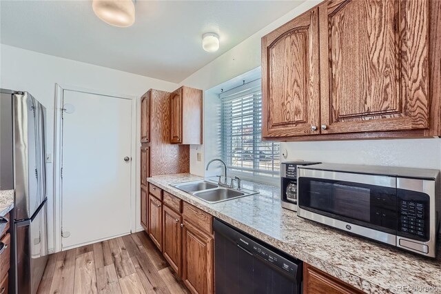 kitchen with light hardwood / wood-style floors, sink, and stainless steel appliances