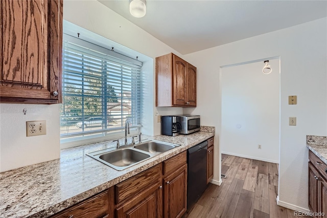 kitchen featuring dishwasher, a healthy amount of sunlight, light wood-type flooring, and sink