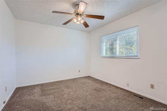 carpeted empty room featuring a textured ceiling and ceiling fan