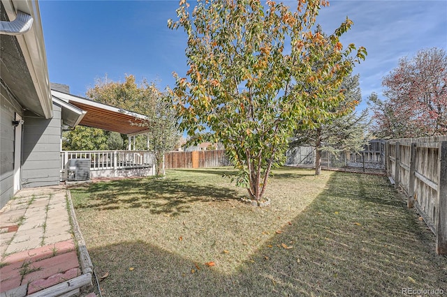 view of yard with central AC unit and a deck