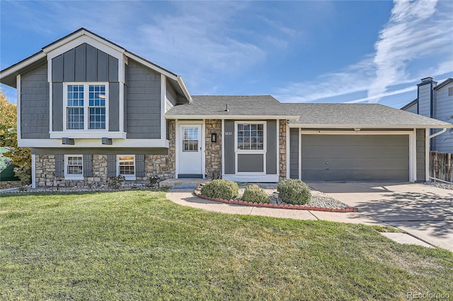 split level home with a garage and a front lawn