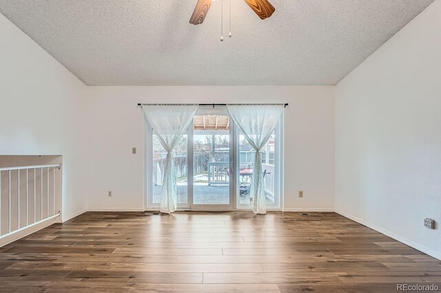 spare room with ceiling fan, dark hardwood / wood-style flooring, and a textured ceiling