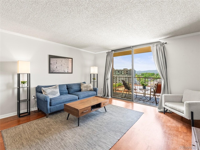 1301 Speer Blvd Unit 702, Denver, CO 80204 - living room with wood finished floors, crown molding, a textured ceiling, and baseboards