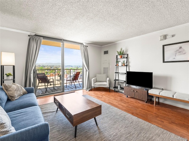 1301 Speer Blvd Unit 702, Denver, CO 80204 - living area with wood finished floors, ornamental molding, a textured ceiling, and floor to ceiling windows