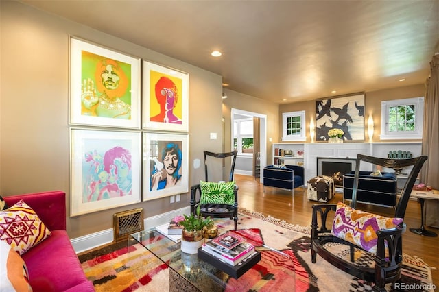 2604 Elm St, Denver, CO 80207 - living room featuring wood finished floors, a lit fireplace, and recessed lighting