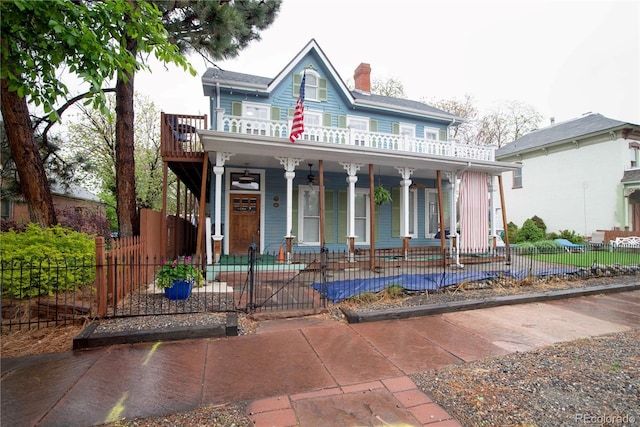 2627 Champa St, Denver, CO 80205 - view of front of home featuring a porch, a chimney, and a fenced front yard