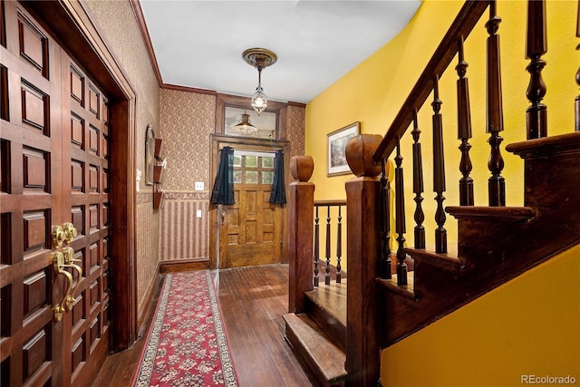 2627 Champa St, Denver, CO 80205 - entryway featuring wallpapered walls, dark wood-type flooring, a wainscoted wall, and stairway