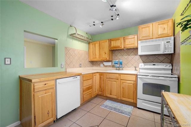 2627 Champa St, Denver, CO 80205 - kitchen featuring white appliances, backsplash, light tile patterned floors, light brown cabinets, and wooden counters