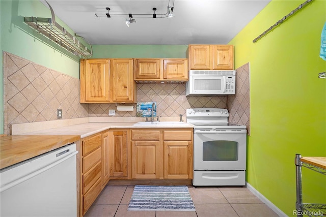 2627 Champa St, Denver, CO 80205 - kitchen featuring white appliances, backsplash, light countertops, and light tile patterned floors