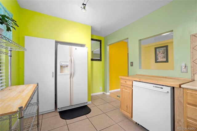2627 Champa St, Denver, CO 80205 - kitchen with white appliances, butcher block countertops, and light tile patterned flooring