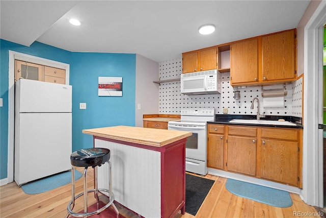2627 Champa St, Denver, CO 80205 - kitchen with white appliances, light wood-type flooring, open shelves, tasteful backsplash, and a kitchen island
