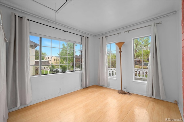 2627 Champa St, Denver, CO 80205 - spare room featuring attic access and light wood-type flooring