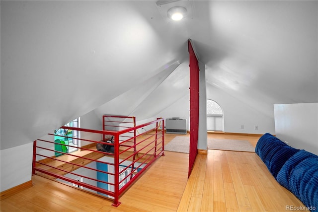 2627 Champa St, Denver, CO 80205 - additional living space featuring vaulted ceiling and wood finished floors